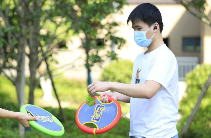 Ball Game With Small Trampoline in Garden